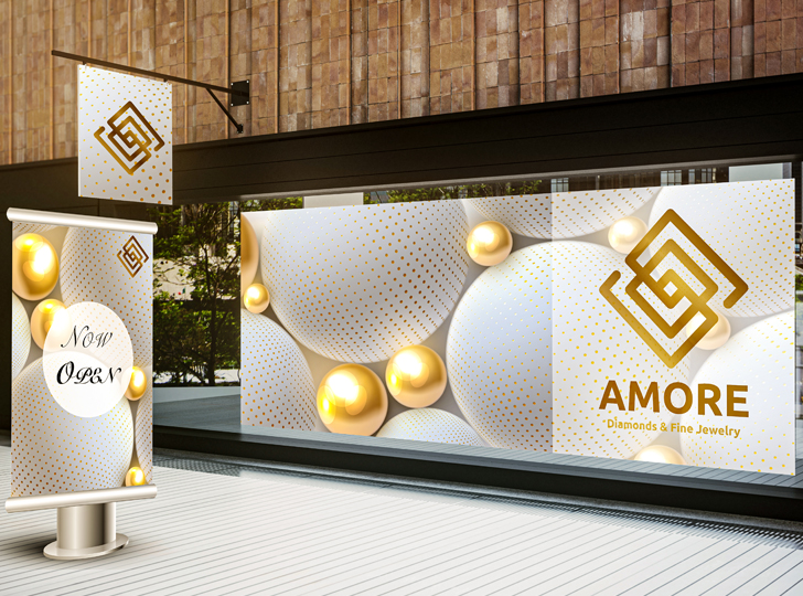 White and gold balls on two signs for Amore Diamonds & Fine Jewelry in gold. 