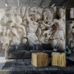 Decal of Roman Statues on wall in front of a couch. 