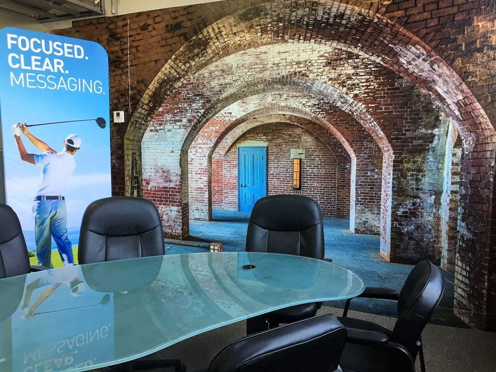 Wall mural with arches and banner that says focused clear messaging