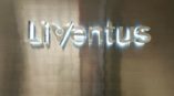 Lit up metal sign that says liventus.