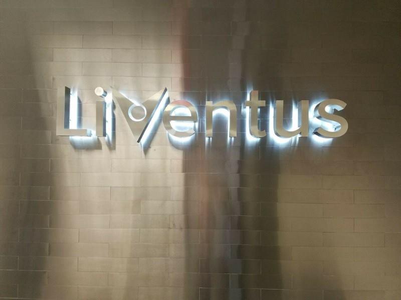 Lit up metal sign that says liventus.