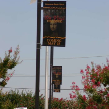 Lamp signage for a segment at a church, two posts in the distance