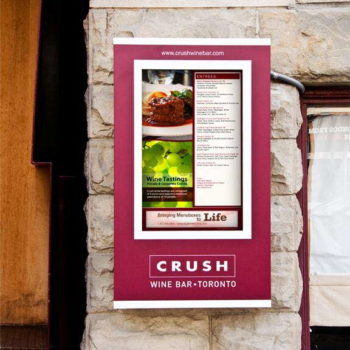 digital wine bar menu signage hanging on stone wall
