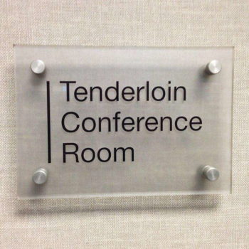Glass sign for on the wall with black font for 