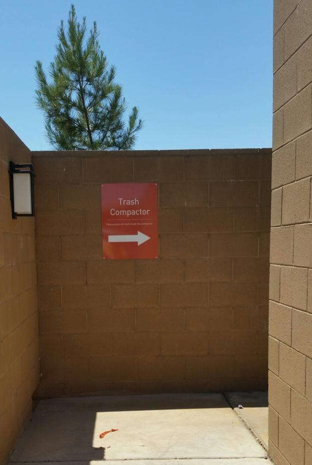 Trash compactor directional signage