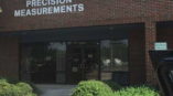 Precision Measurements sign on brick building
