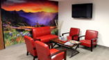 Full wall mural of a sunset over mountains in an office lobby