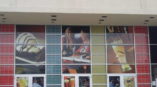Nightlife advertisements on wall of desert beers and people having fun