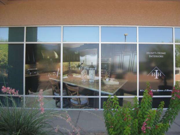 Hunt's Home interiors full window advertisement display of chairs and table