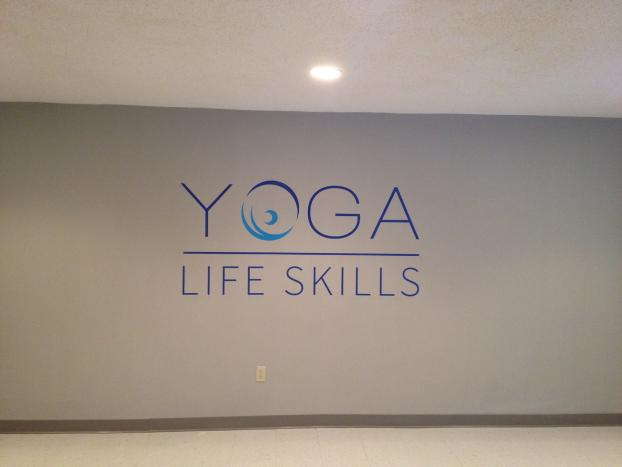 Yoga Life Skills logo on wall